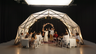 Konligo Fastival event structure with white membrane used as a wedding canopy, featuring guests toasting newlyweds at a dinner reception, now available on MTN Shop US.