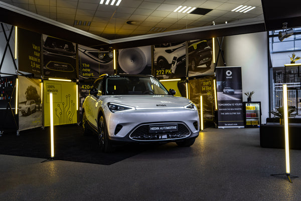 Konligo modular Luno Wall structure used as an illuminated indoor display booth for Hedin Automotive featuring a white electric vehicle, now available on MTN SHOP US.