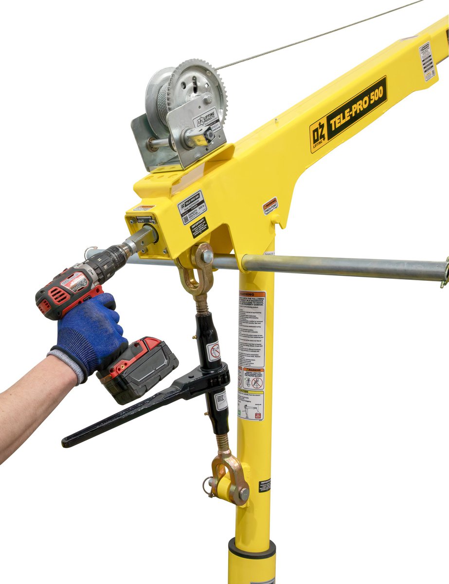 OZ Lifting OZWINHND2 carbon steel brake winch with drill drive adapter and electric drill on yellow crane setup - imagen 5