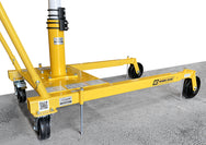 An OZ Lifting Products yellow Davit crane mobile wheel base showing the floor-anchor kit pins extended into a concrete floor for stability, isolated on a white background.